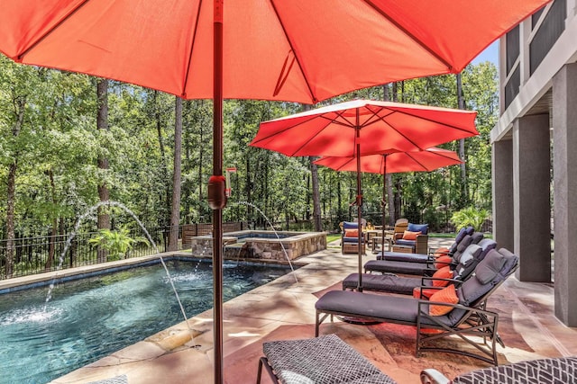 view of pool featuring a patio area, pool water feature, and an in ground hot tub