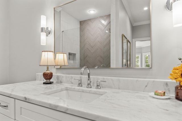 bathroom featuring crown molding and vanity