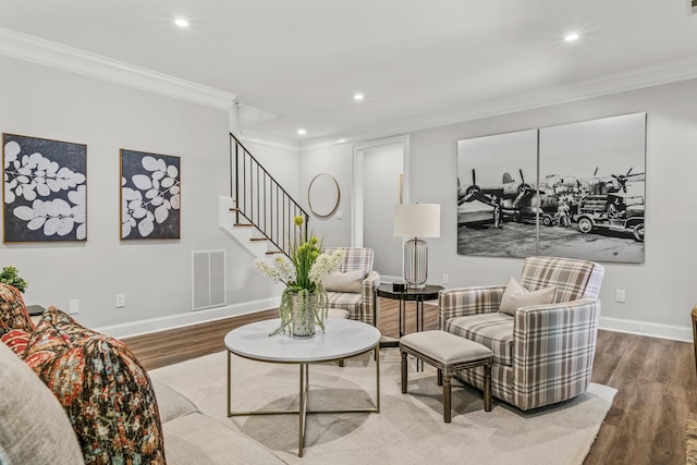 living room with crown molding and wood-type flooring