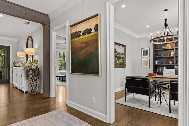 hallway featuring ornamental molding, dark hardwood / wood-style floors, and a notable chandelier