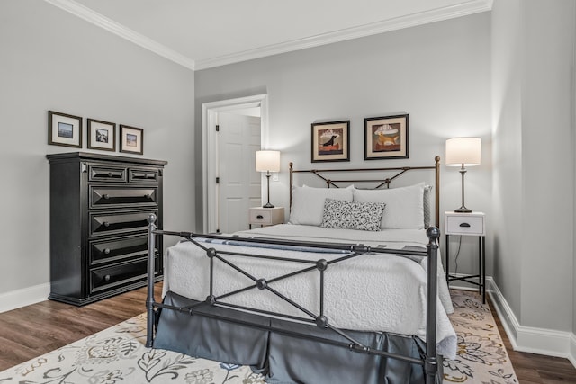 bedroom featuring dark hardwood / wood-style flooring and crown molding