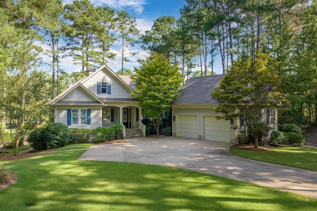 view of front of property with a garage and a front lawn