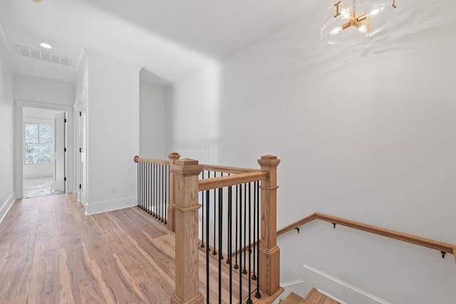 1358 Veranda Park Dr, Madison, GA 30650 - hallway with a chandelier, an upstairs landing, visible vents, baseboards, and light wood finished floors