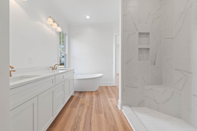 1358 Veranda Park Dr, Madison, GA 30650 - full bathroom featuring double vanity, wood finished floors, a soaking tub, and a sink