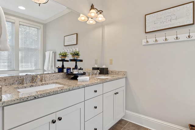 bathroom with a notable chandelier, vanity, ornamental molding, and tile patterned floors