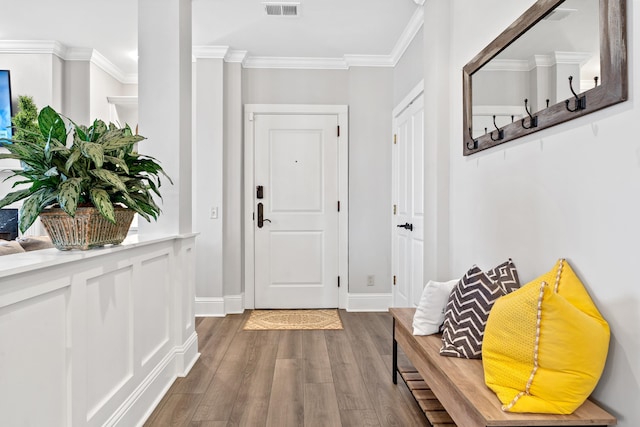 interior space featuring crown molding and hardwood / wood-style flooring