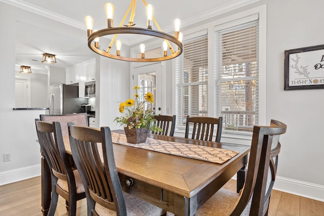 dining area with crown molding, light hardwood / wood-style floors, and a notable chandelier