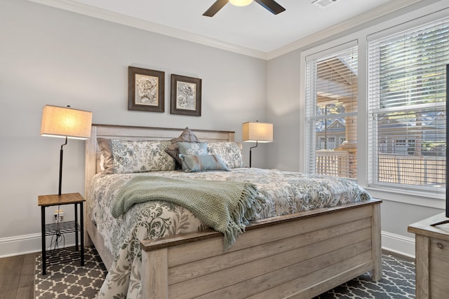 bedroom featuring ceiling fan, ornamental molding, and dark hardwood / wood-style flooring