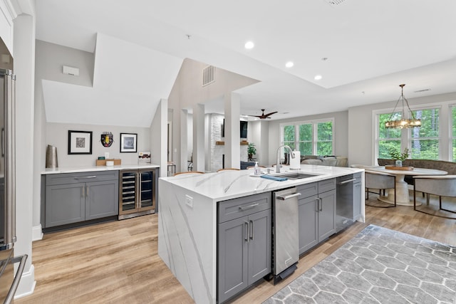 1010F Tailwater, Greensboro, GA 30642 - kitchen with a sink, visible vents, beverage cooler, light wood-style flooring, and gray cabinetry