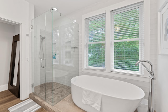 1010F Tailwater, Greensboro, GA 30642 - full bathroom with a freestanding bath, a shower stall, a wealth of natural light, and wood finished floors