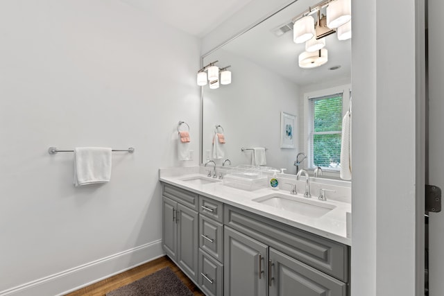 1010F Tailwater, Greensboro, GA 30642 - bathroom featuring a sink, double vanity, wood finished floors, and visible vents