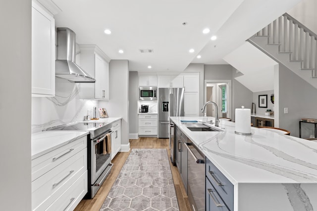 1010F Tailwater, Greensboro, GA 30642 - kitchen with visible vents, a large island, wall chimney exhaust hood, a sink, and stainless steel appliances