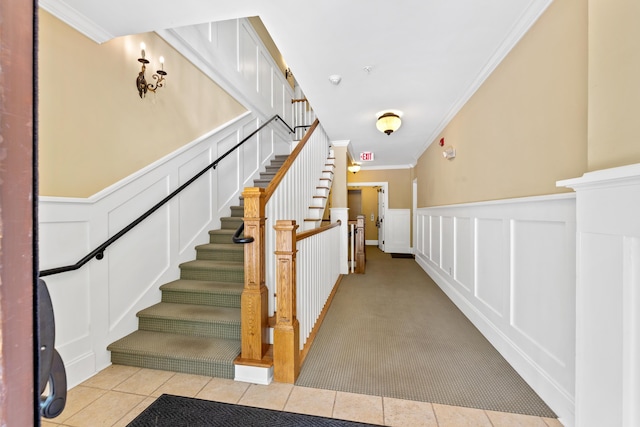 1010F Tailwater, Greensboro, GA 30642 - stairs with crown molding, a wainscoted wall, tile patterned flooring, and a decorative wall