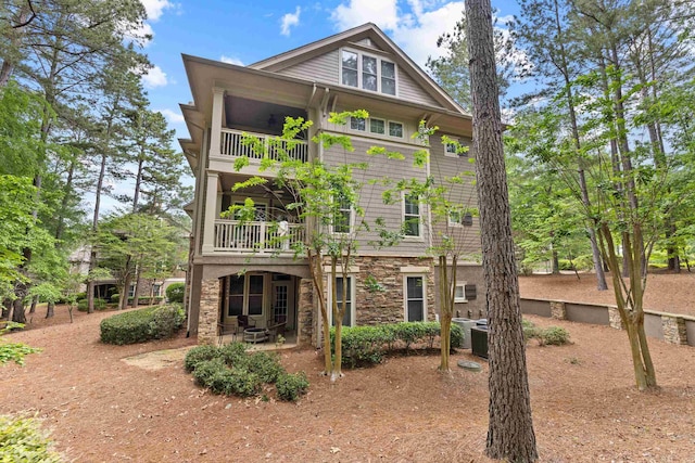 1010F Tailwater, Greensboro, GA 30642 - back of property with a balcony, stone siding, and a patio area