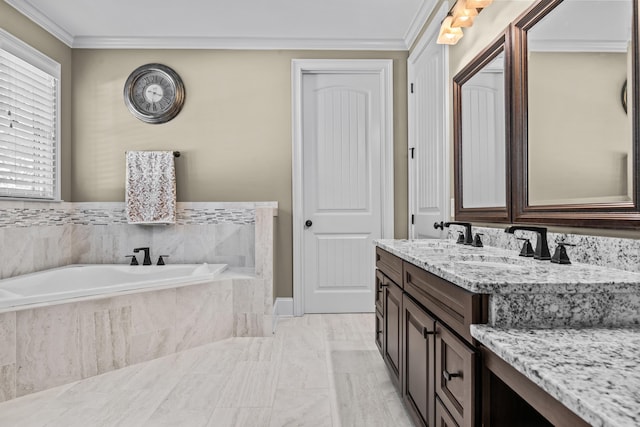 bathroom featuring vanity, crown molding, and tiled bath