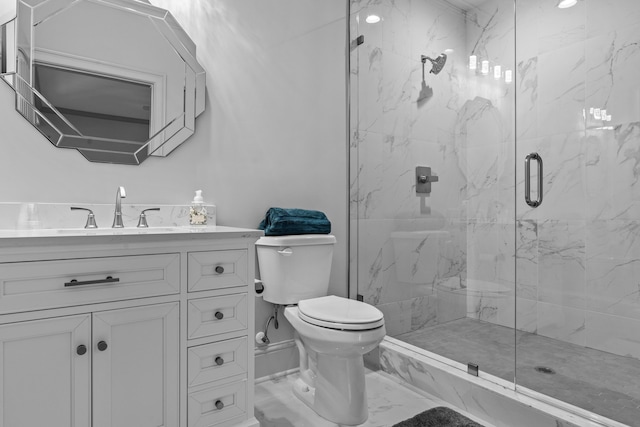 bathroom featuring vanity, toilet, and a shower with shower door