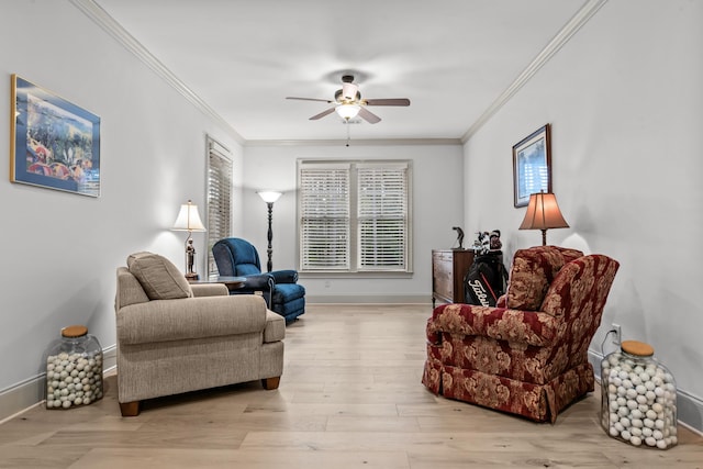 living room featuring ceiling fan, ornamental molding, and light hardwood / wood-style floors