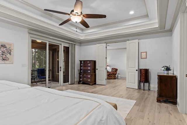 bedroom with crown molding, ceiling fan, access to exterior, light hardwood / wood-style floors, and a raised ceiling