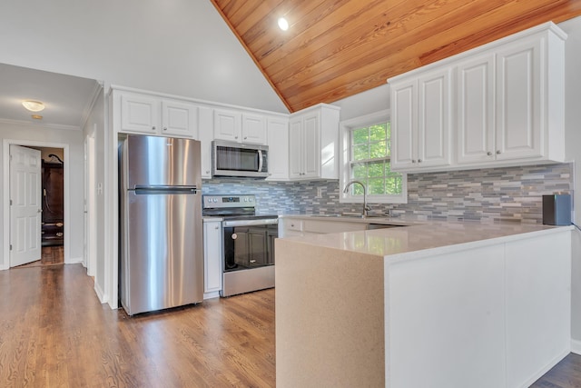 kitchen with sink, light hardwood / wood-style flooring, stainless steel appliances, white cabinets, and kitchen peninsula