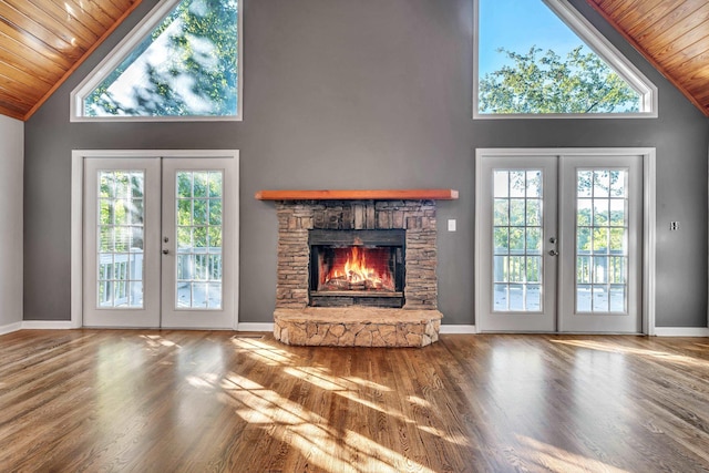 unfurnished living room with hardwood / wood-style flooring, wooden ceiling, and french doors