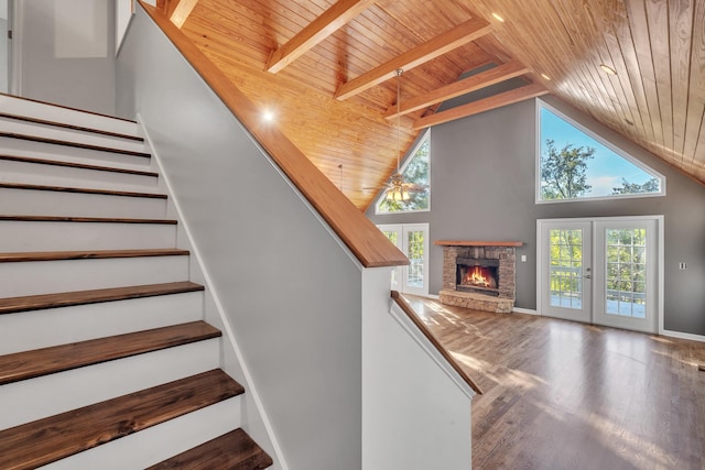 stairs featuring wood ceiling, a healthy amount of sunlight, hardwood / wood-style floors, and french doors