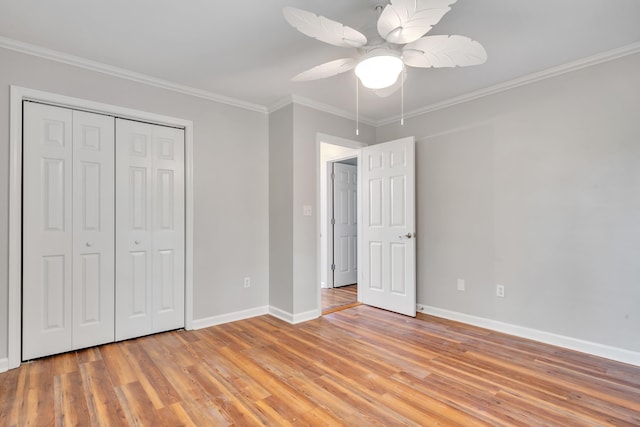 unfurnished bedroom featuring ceiling fan, a closet, ornamental molding, and light hardwood / wood-style flooring