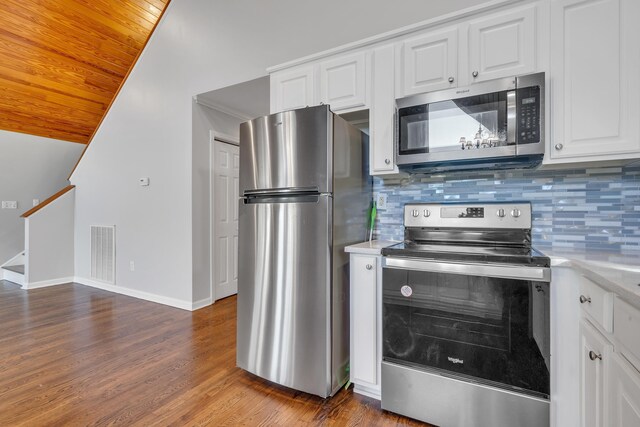 kitchen featuring appliances with stainless steel finishes, dark hardwood / wood-style floors, white cabinets, and backsplash