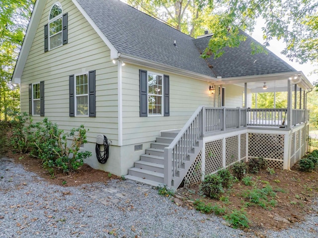 back of house with ceiling fan and covered porch