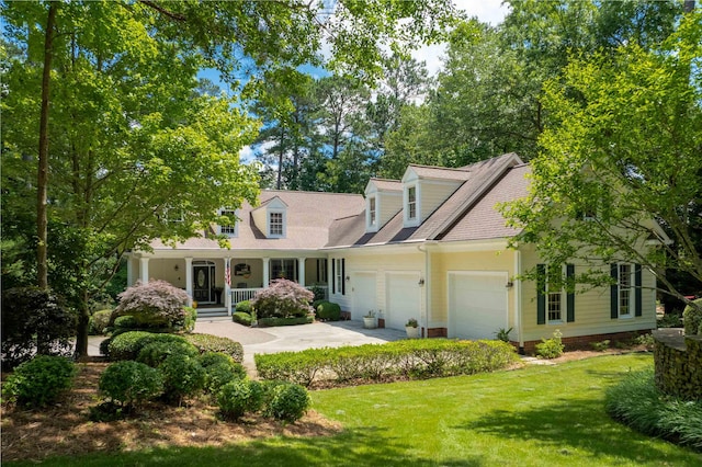 cape cod home featuring a porch, a garage, and a front lawn