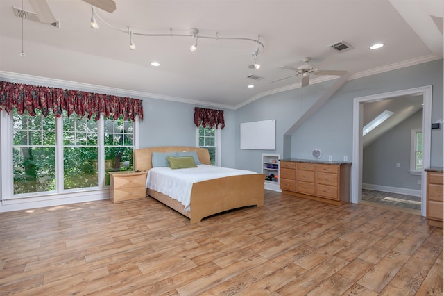 bedroom featuring crown molding, lofted ceiling, and light wood-type flooring