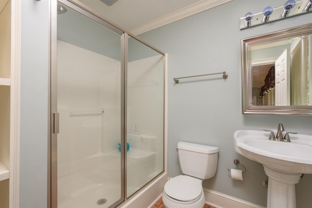 bathroom featuring ornamental molding, an enclosed shower, and toilet