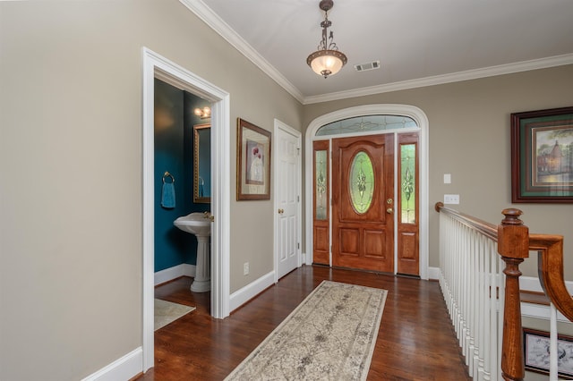 foyer featuring crown molding and dark hardwood / wood-style floors