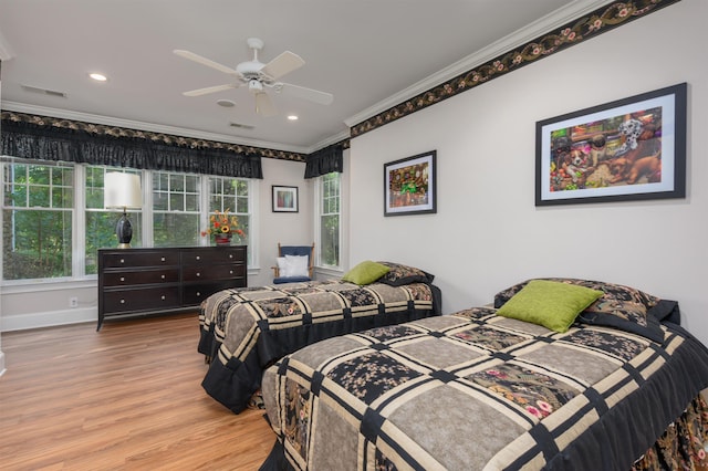 bedroom featuring crown molding, ceiling fan, and light hardwood / wood-style floors