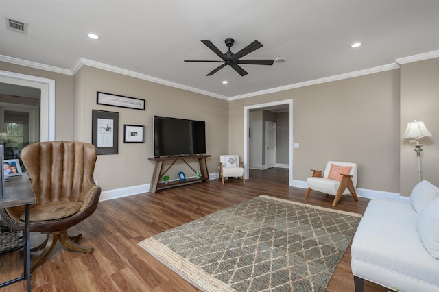 living room with wood-type flooring, ornamental molding, and ceiling fan