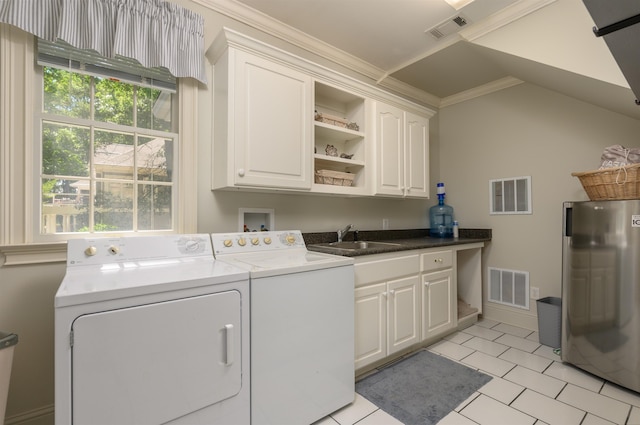 washroom featuring sink, cabinets, light tile patterned floors, independent washer and dryer, and crown molding