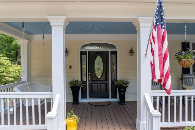 view of exterior entry featuring a porch