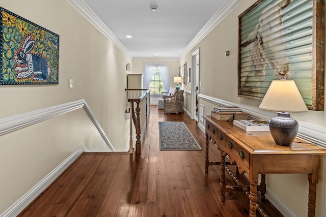 hallway with baseboards, an upstairs landing, hardwood / wood-style flooring, and ornamental molding