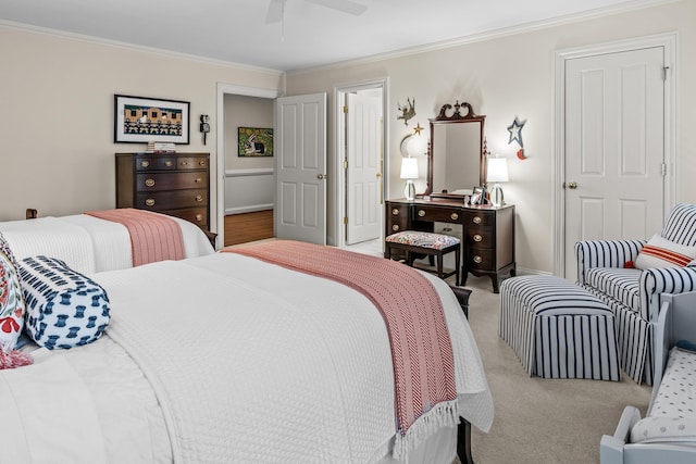 carpeted bedroom featuring baseboards, crown molding, and ceiling fan
