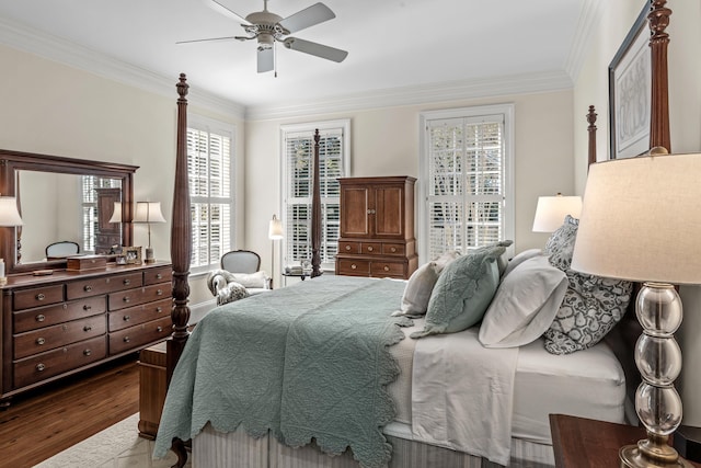 bedroom featuring crown molding, wood finished floors, and a ceiling fan