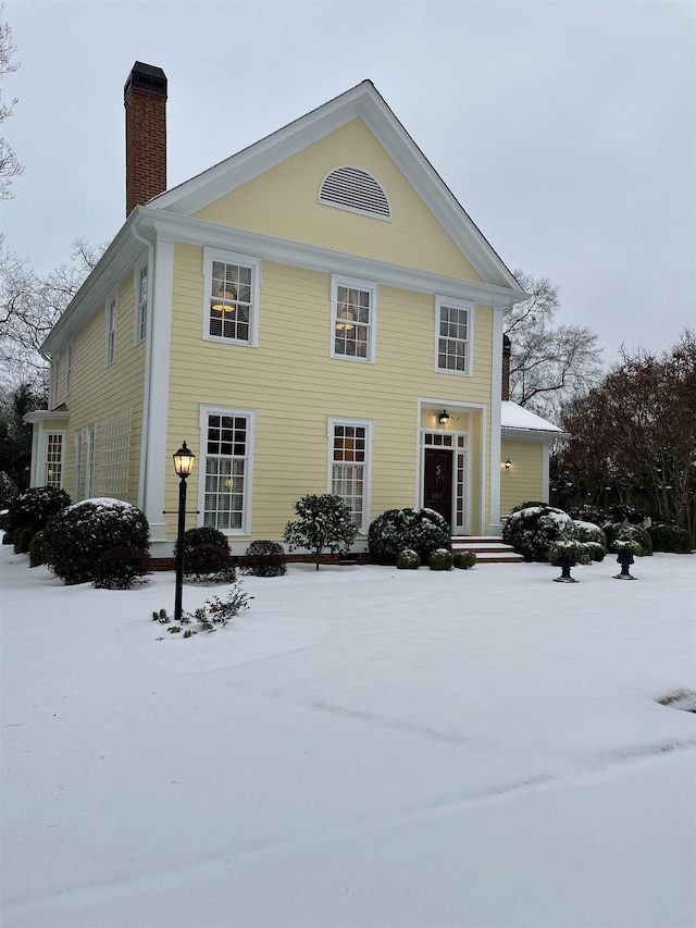 greek revival house with a chimney