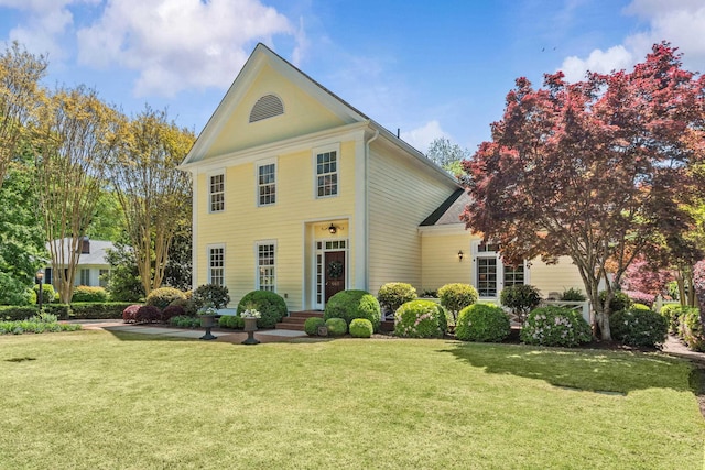 greek revival house featuring a front lawn