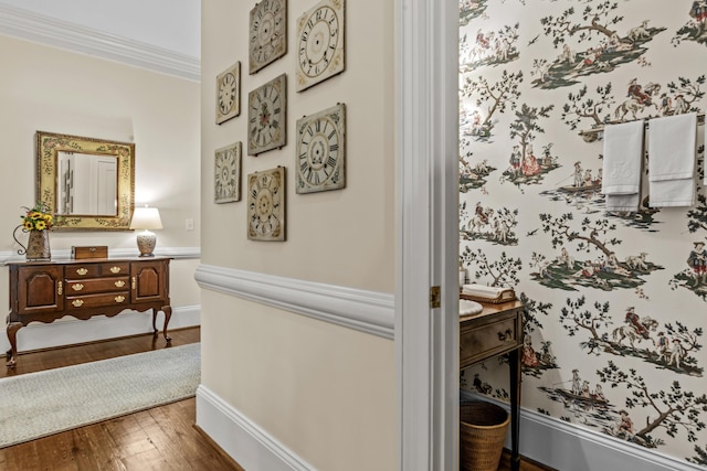 hallway featuring dark wood-type flooring, baseboards, and crown molding