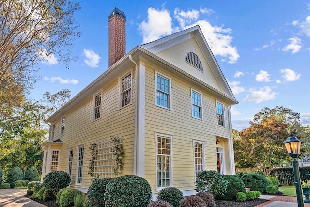 view of property exterior featuring a chimney