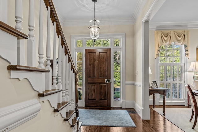 foyer entrance featuring dark wood-type flooring, a healthy amount of sunlight, and stairs