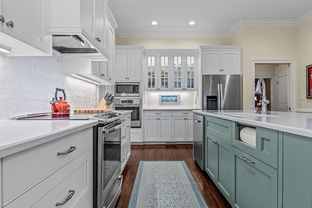 kitchen with white cabinets, light countertops, and appliances with stainless steel finishes
