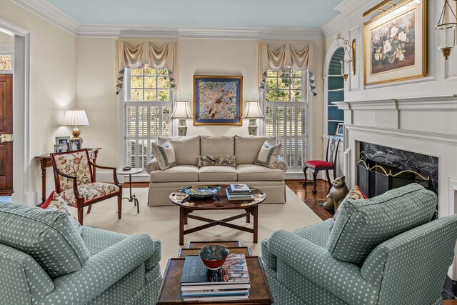 living area featuring ornamental molding, a wealth of natural light, and a fireplace