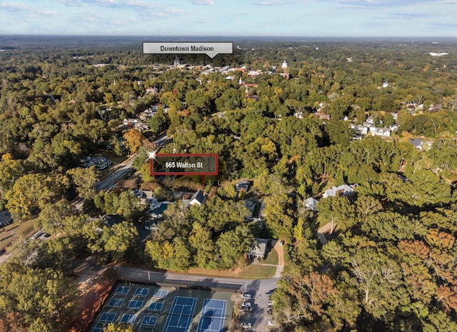 bird's eye view with a wooded view