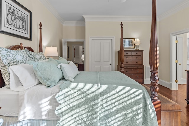 bedroom featuring ornamental molding, baseboards, and wood finished floors