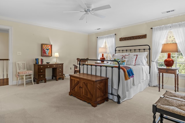 bedroom featuring visible vents, multiple windows, ornamental molding, and carpet floors