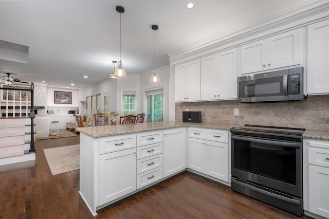1020 Tallesse Trl, Greensboro, GA 30642 - kitchen with appliances with stainless steel finishes, a peninsula, open floor plan, recessed lighting, and decorative backsplash